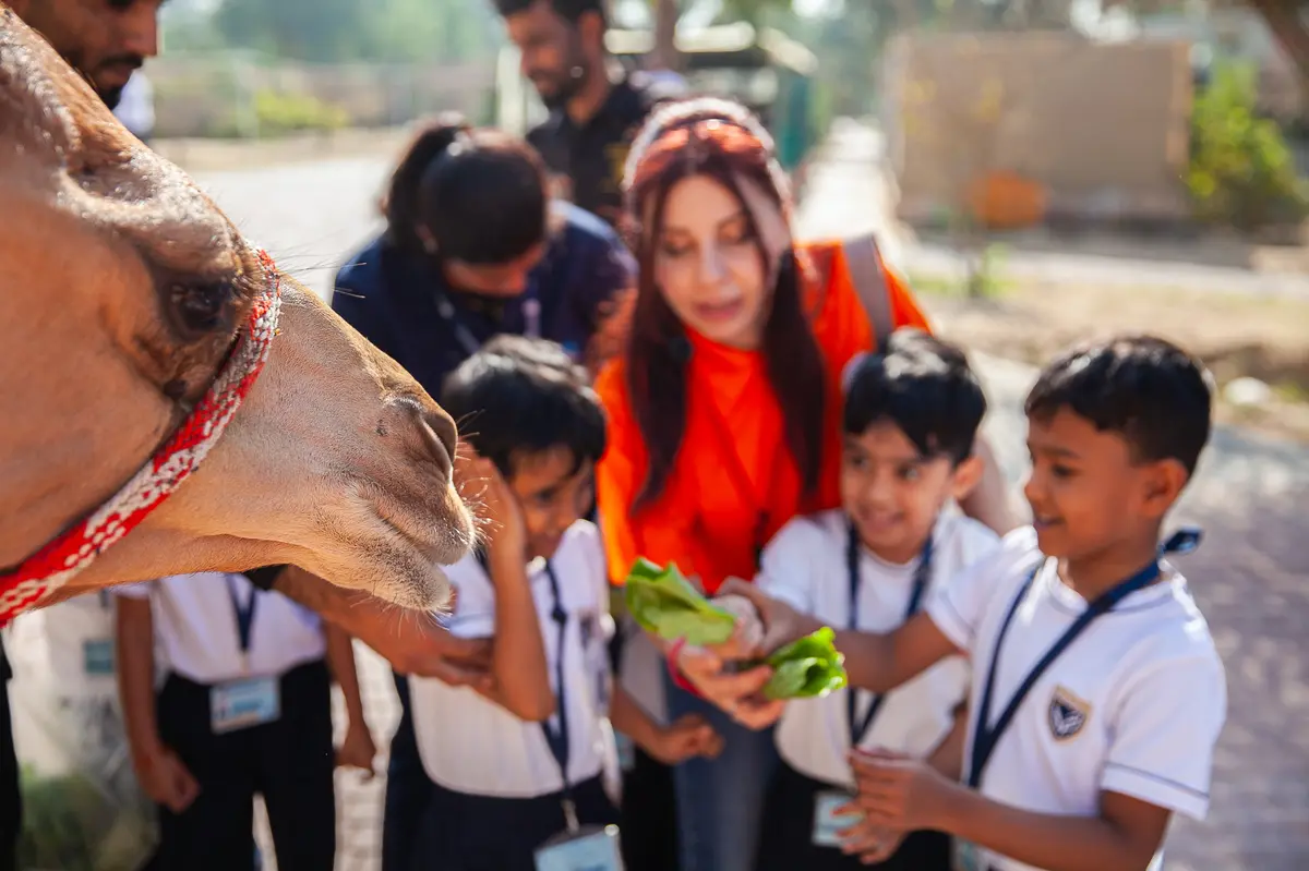 Students on a UAE local Emirati farm field trip with Dubai by Foot learning about agriculture and animals