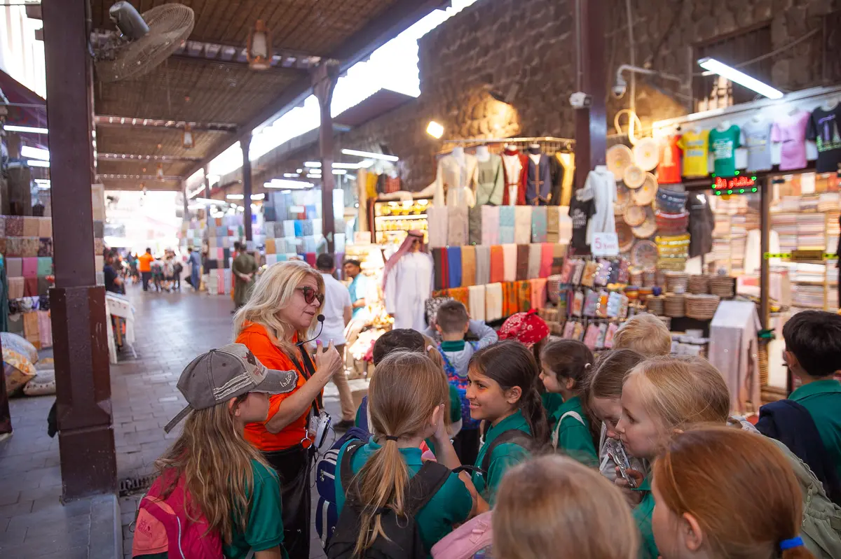 Students on a Dubai by Foot heritage field trip exploring the souks and Al Fahidi neighborhood in Old Dubai